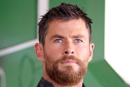 Chris Hemsworth short spiky dark hair with textured layered cut, styled slightly tousled in a well-groomed manner