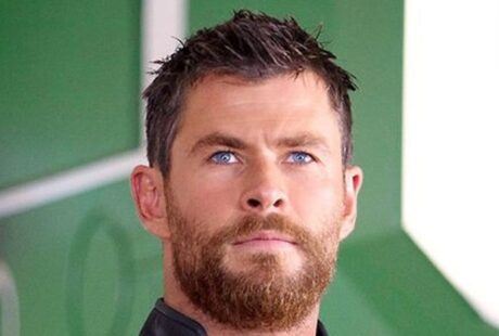 Chris Hemsworth short spiky dark hair with textured layered cut, styled slightly tousled in a well-groomed manner