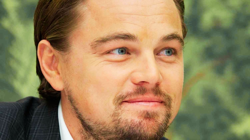 Close-up of Leonardo DiCaprio with medium-length hair slicked back with slight volume at the crown, Great Gatsby style