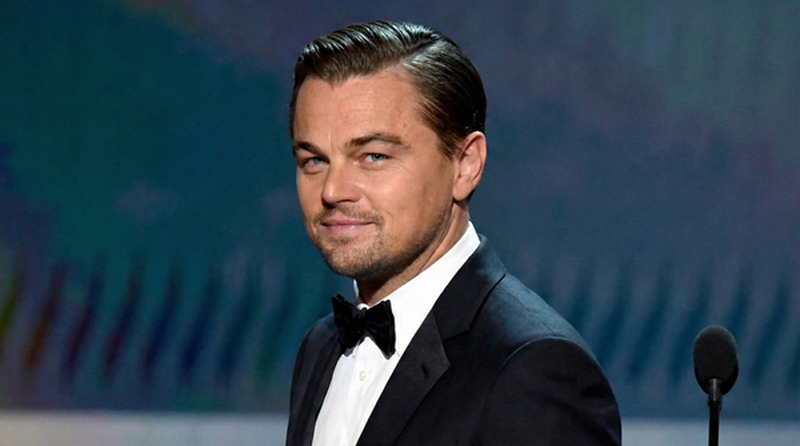 Leonardo DiCaprio's sleek side-parted hairstyle combed back neatly as Jordan Belfort in The Wolf of Wall Street