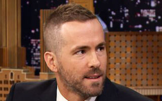 Ryan Reynolds Deadpool haircut with clean fade sides and longer textured top styled upward