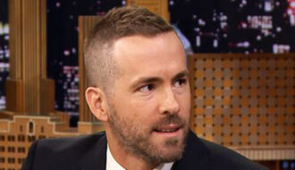 Ryan Reynolds Deadpool haircut with clean fade sides and longer textured top styled upward