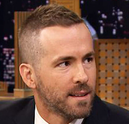 Ryan Reynolds Deadpool haircut with clean fade sides and longer textured top styled upward