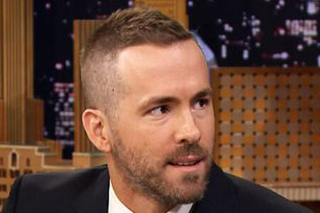 Ryan Reynolds Deadpool haircut with clean fade sides and longer textured top styled upward