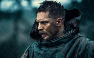 Tom Hardy with spiky textured top and sharp fade paired with a thick beard