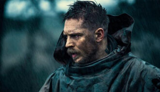 Tom Hardy with spiky textured top and sharp fade paired with a thick beard