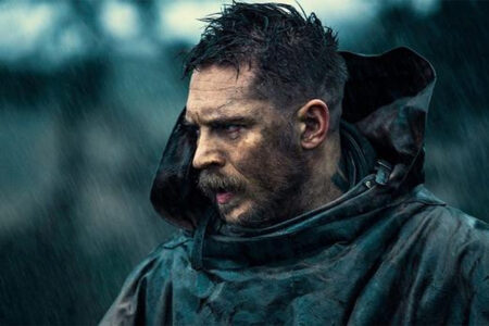 Tom Hardy with spiky textured top and sharp fade paired with a thick beard