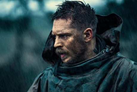 Tom Hardy with spiky textured top and sharp fade paired with a thick beard