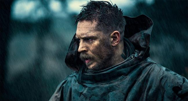 Tom Hardy with spiky textured top and sharp fade paired with a thick beard